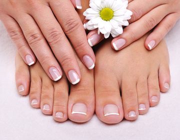 Skincare of a beauty female feet with camomile’s flower Skincare of a beauty female feet with camomile's flower